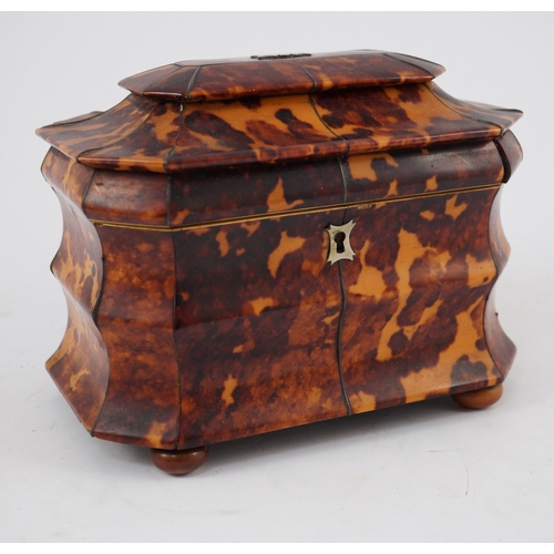 39 - A Regency blond tortoiseshell sarcophagus shaped tea caddy, of octagonal form, with ivory inner band... 