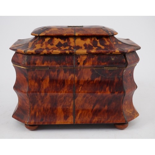 39 - A Regency blond tortoiseshell sarcophagus shaped tea caddy, of octagonal form, with ivory inner band... 