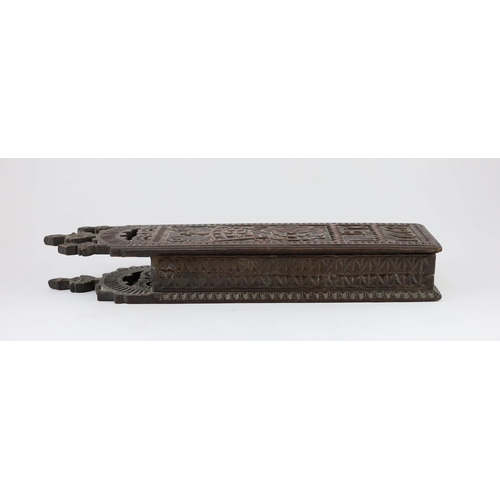 40 - An antique carved oak cased tobacco rasp, the wall mounting case carved in relief with a crowned ros... 