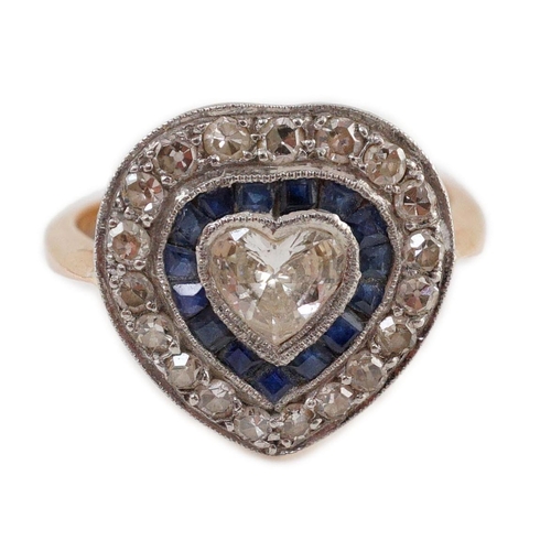 403 - A 1920's, gold and platinum, millegrain set sapphire and diamond cluster set ring, with central hear... 