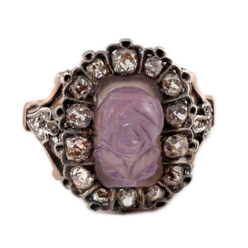 404 - A 19th century gold, carved amethyst and diamond cluster set dress ring, the stone carved with a ros... 