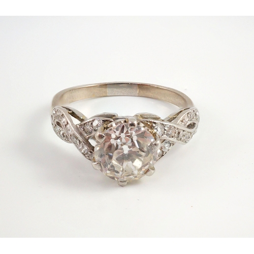 415 - A mid 20th century white gold and single stone diamond ring, with diamond set crossover shoulders, t... 