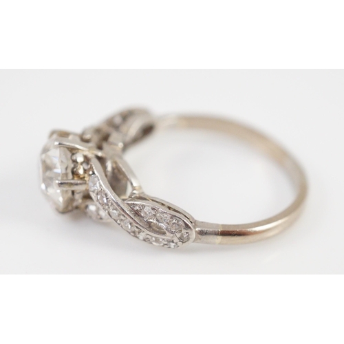 415 - A mid 20th century white gold and single stone diamond ring, with diamond set crossover shoulders, t... 