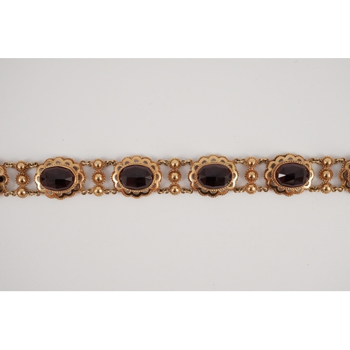 417 - A 20th century Dutch 14k gold and six stone facet cut cabochon garnet set fancy link bracelet, 19cm,... 