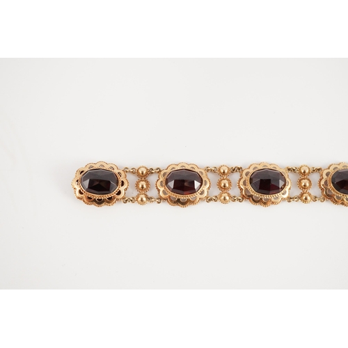 417 - A 20th century Dutch 14k gold and six stone facet cut cabochon garnet set fancy link bracelet, 19cm,... 