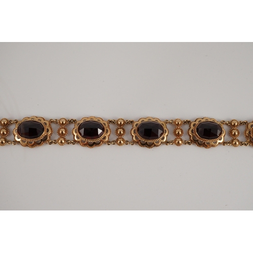 417 - A 20th century Dutch 14k gold and six stone facet cut cabochon garnet set fancy link bracelet, 19cm,... 