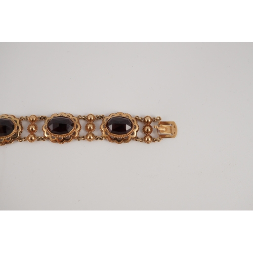 417 - A 20th century Dutch 14k gold and six stone facet cut cabochon garnet set fancy link bracelet, 19cm,... 