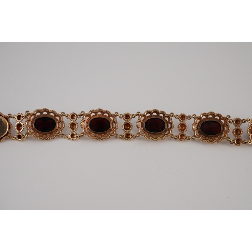 417 - A 20th century Dutch 14k gold and six stone facet cut cabochon garnet set fancy link bracelet, 19cm,... 