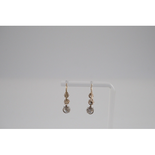 422 - A pair of early to mid 20th century gold, platinum and graduated three stone diamond set drop earrin... 