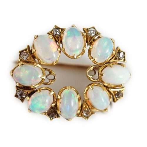 423 - An Edwardian gold, eight stone oval opal set oval brooch, with diamond chip spacers, 20mm, gross wei... 