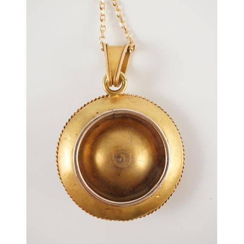 428 - A Victorian gold circular pendant, with flower head centre and glazed back, on a later 9ct gold chai... 