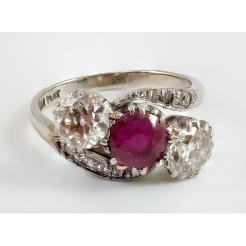 432 - An 18ct white gold and platinum, two stone diamond and single stone synthetic? ruby set crossover ri... 