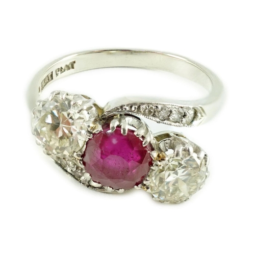 432 - An 18ct white gold and platinum, two stone diamond and single stone synthetic? ruby set crossover ri... 