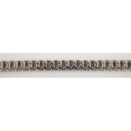 436 - A modern 18ct white gold and emerald cut diamond set line bracelet, the sixty nine stones with a tot... 