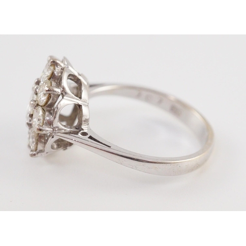 438 - A modern 18ct white gold and nine stone diamond illusion set circular cluster ring, size M/N, gross ... 