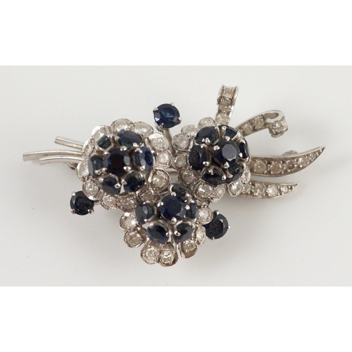 439 - A white gold, sapphire and diamond cluster set floral spray brooch, 53mm, gross weight 18.8 grams.... 