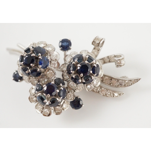 439 - A white gold, sapphire and diamond cluster set floral spray brooch, 53mm, gross weight 18.8 grams.... 