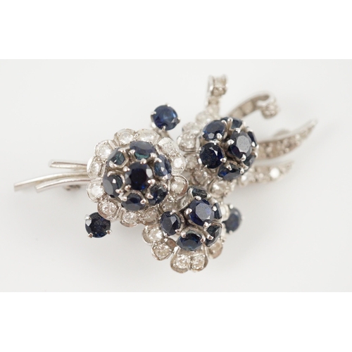 439 - A white gold, sapphire and diamond cluster set floral spray brooch, 53mm, gross weight 18.8 grams.... 