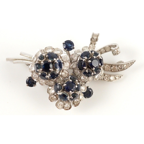 439 - A white gold, sapphire and diamond cluster set floral spray brooch, 53mm, gross weight 18.8 grams.... 