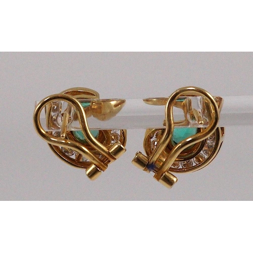 441 - A modern pair of gold (tests as 18ct), emerald and diamond set scrolling cluster earrings, total eme... 