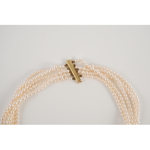 443 - A quintuple strand seed pearl choker necklace, with pierced gold, platinum and diamond cluster set q... 