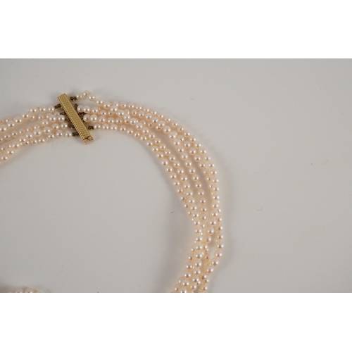 443 - A quintuple strand seed pearl choker necklace, with pierced gold, platinum and diamond cluster set q... 