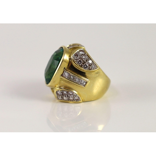 444 - A large gold and single stone oval cut emerald set dress ring, with round and princess cut diamond c... 