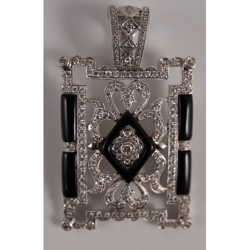 446 - A modern 1920's style pierced 18k white gold, diamond and black onyx set rectangular pendant, the to... 