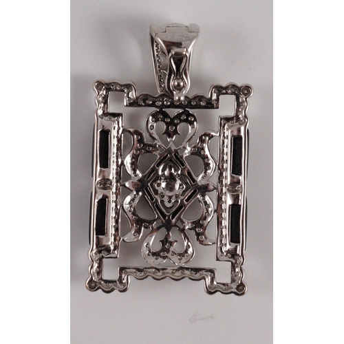 446 - A modern 1920's style pierced 18k white gold, diamond and black onyx set rectangular pendant, the to... 