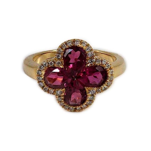 451 - A modern 18k gold four stone pear shaped pink tourmaline set dress ring with diamond chip set border... 