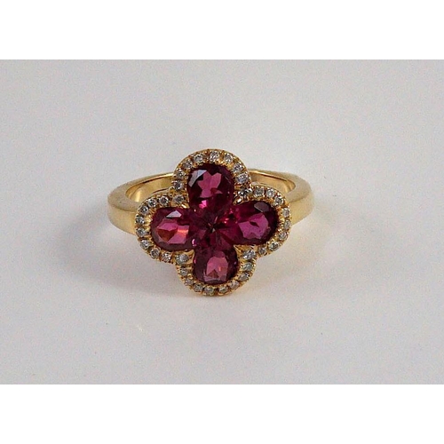 451 - A modern 18k gold four stone pear shaped pink tourmaline set dress ring with diamond chip set border... 