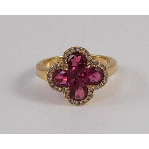 451 - A modern 18k gold four stone pear shaped pink tourmaline set dress ring with diamond chip set border... 