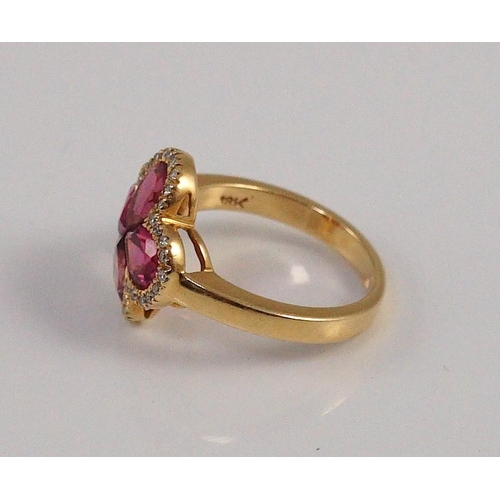 451 - A modern 18k gold four stone pear shaped pink tourmaline set dress ring with diamond chip set border... 