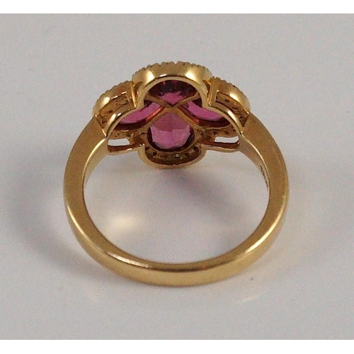 451 - A modern 18k gold four stone pear shaped pink tourmaline set dress ring with diamond chip set border... 