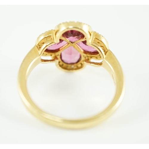 451 - A modern 18k gold four stone pear shaped pink tourmaline set dress ring with diamond chip set border... 