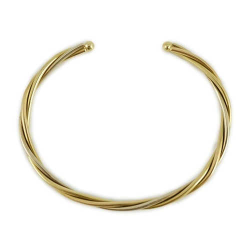 460 - A modern Cartier 18k gold spiral twist open work bangle, signed and numbered 107998, 15 grams.... 