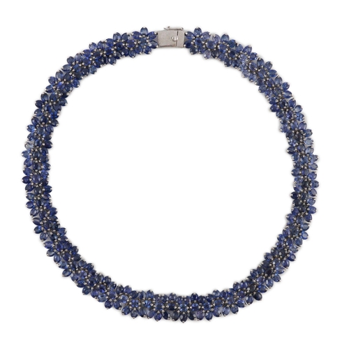 465 - An 18K white gold and synthetic sapphire? flower head cluster set necklace, gross weight 65 grams.... 