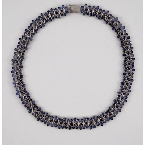 465 - An 18K white gold and synthetic sapphire? flower head cluster set necklace, gross weight 65 grams.... 