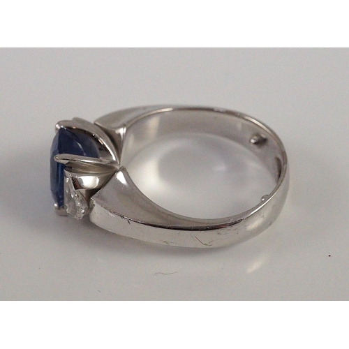 466 - A modern white gold (tests as 18ct),  single stone oval cut Ceylon sapphire and two stone shield cut... 