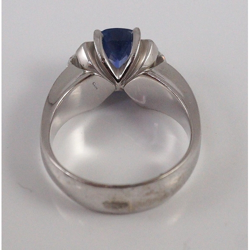 466 - A modern white gold (tests as 18ct),  single stone oval cut Ceylon sapphire and two stone shield cut... 