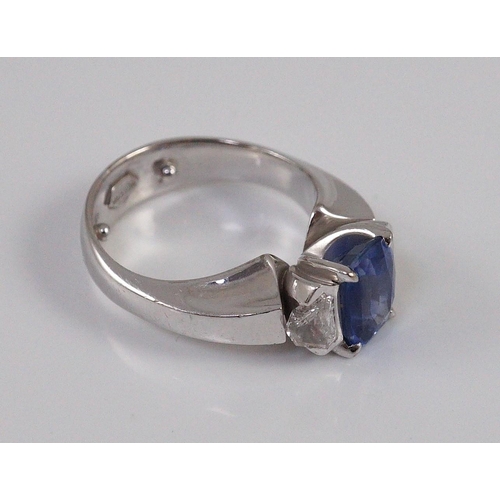 466 - A modern white gold (tests as 18ct),  single stone oval cut Ceylon sapphire and two stone shield cut... 