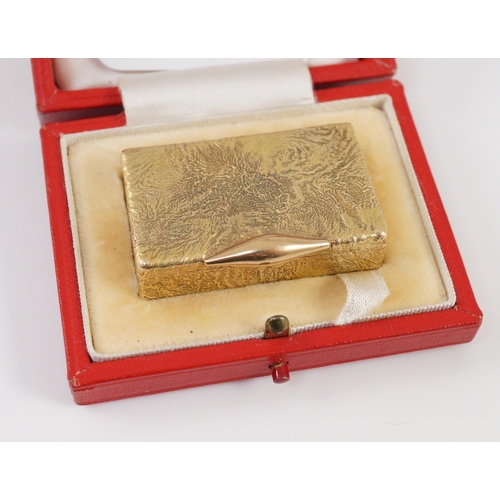 472 - A 1960's 9ct gold Cartier rectangular pill box, with samorodok decoration, signed Cartier, London an... 