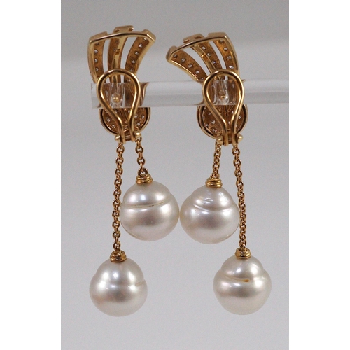 479 - A modern pair of gold (tests as 18ct) and two stone South Sea pearl and diamond cluster set double d... 