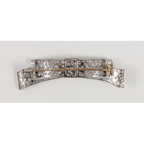 484 - A mid 20th century white gold and pave set diamond ribbon bow brooch, the stones in an abstract scro... 