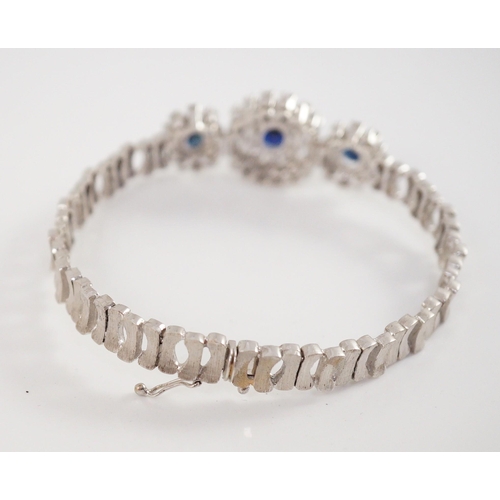 485 - A mid to late 20th century textured 18k white gold, sapphire, round and baguette cut diamond set tri... 