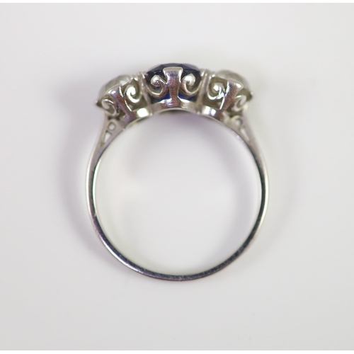 486 - A platinum two stone diamond and single stone sapphire ring, the total diamond weight approximately ... 