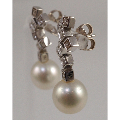 487 - A modern pair of 18ct white gold, single stone South Sea pearl and eight stone diamond cluster set d... 