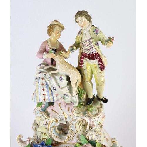 77 - An impressive German porcelain floral encrusted figural mantel clock, late 19th century, modelled wi... 