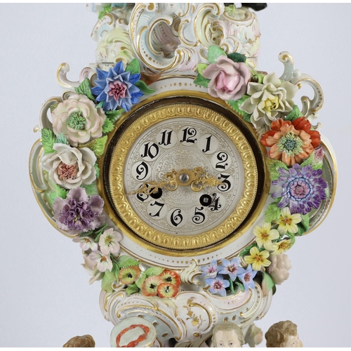 77 - An impressive German porcelain floral encrusted figural mantel clock, late 19th century, modelled wi... 