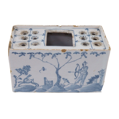 80 - An English delftware flower brick, mid 18th century, painted with Chinese figures in European landsc... 